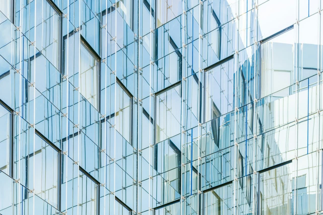 Geometric reflections across a modern glass building
